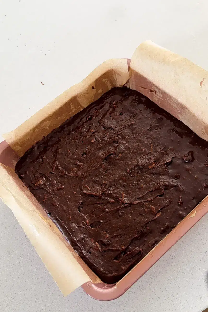 Batter added to lined baking tin
