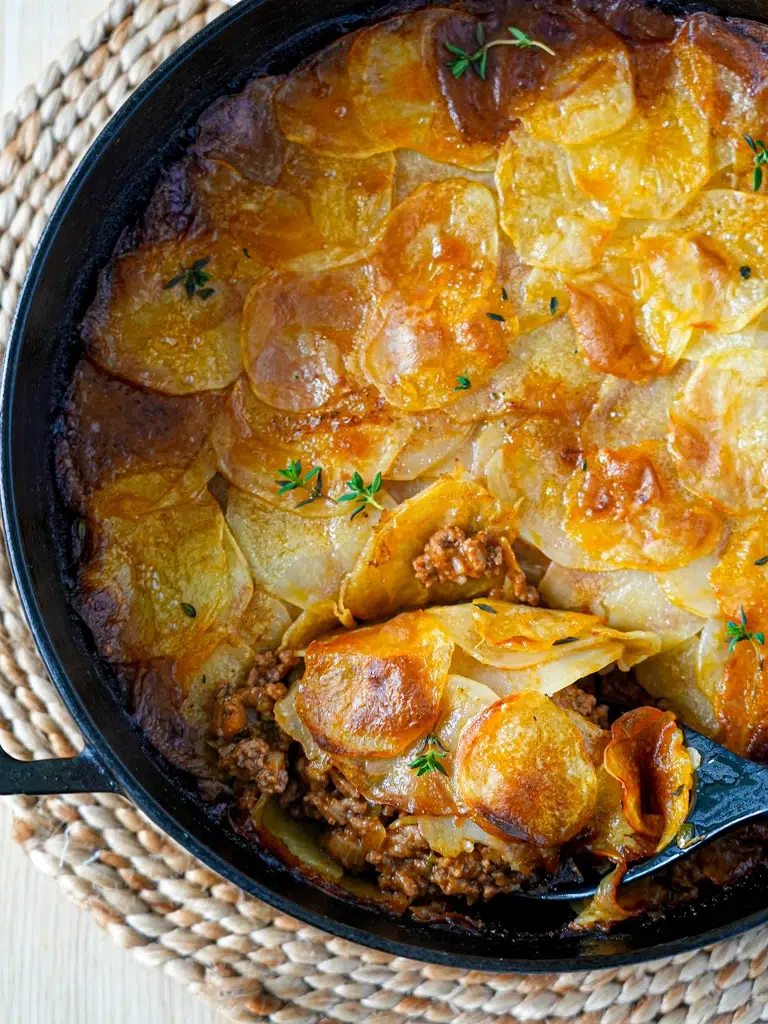 Full beef and potato pie in one pan, with a golden flaky crust.