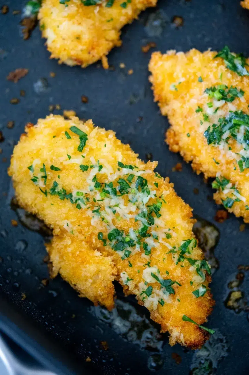 Garlic butter brushed over hot chicken tenders, then sprinkled with parmesan so it melts into the crumb – the easiest way to turn simple chicken into something everyone fights over.